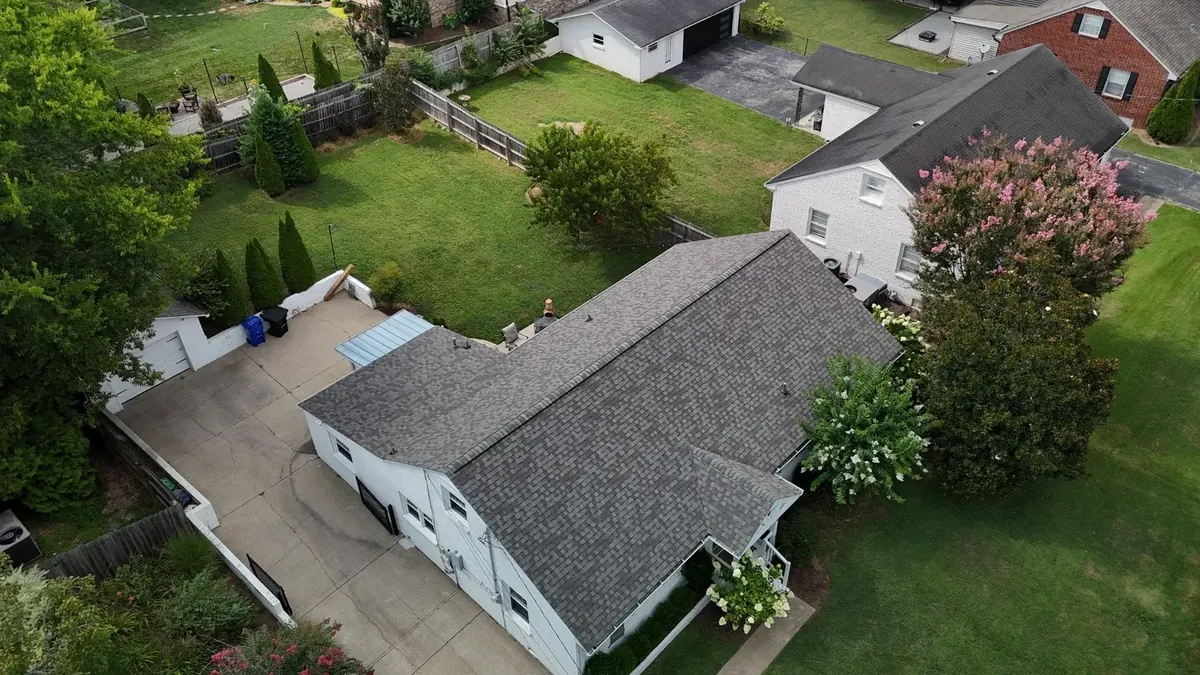 Aerial view of a new shingle roof installed on a suburban home